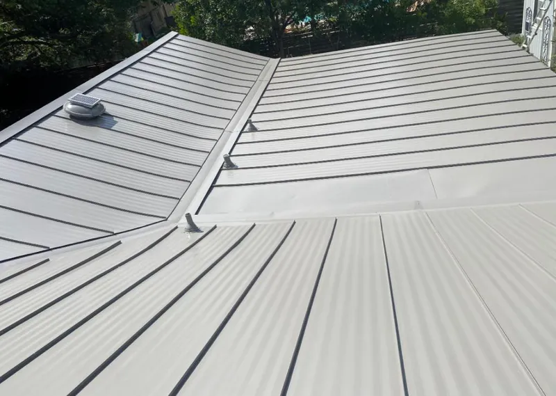 Solar attic fan installed on a metal roof for Roof Ventilation in Universal City
